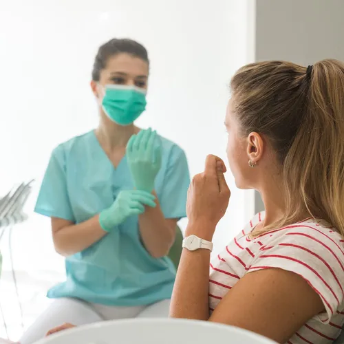 female medical professional talking with a female patient