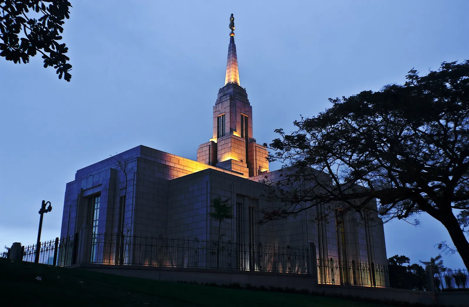 Lights shine on the Cebu City Philippines Temple at night.