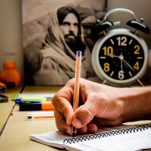 a hand writing in a notebook