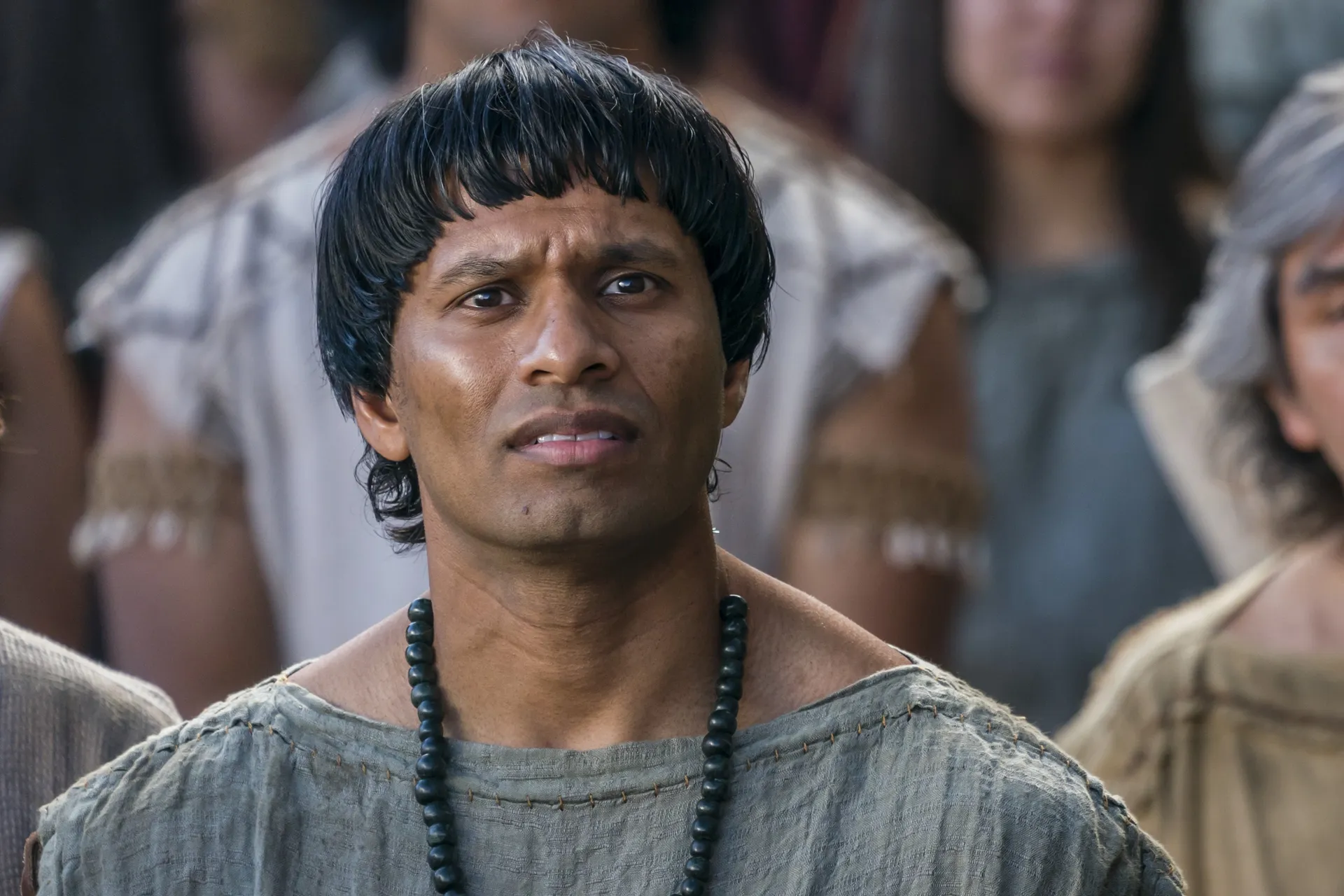 A man listens as Alma the Younger preaches to the people of Gideon.