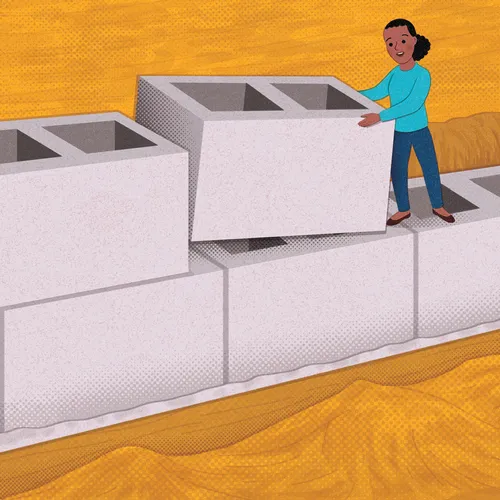 young woman laying oversized bricks as a foundation