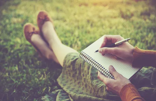 young woman writing in a notebook