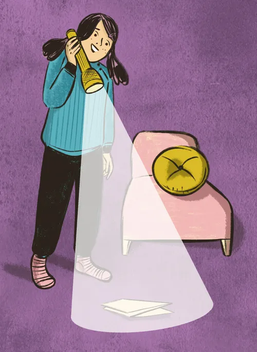 Girl shining a flashlight on the floor