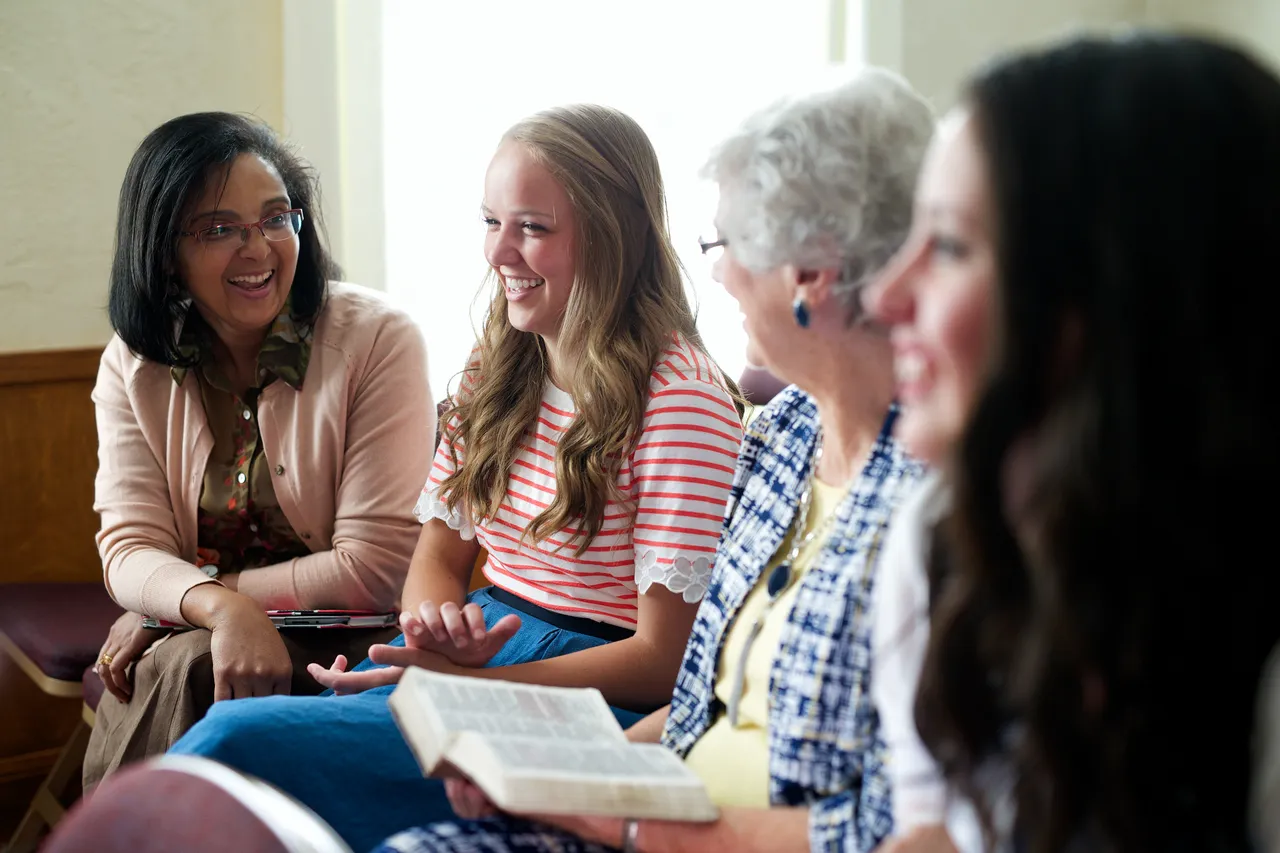 A group of women, young and old, talking in a Relief Society class