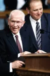 President Ezra Taft Benson standing next to Thomas S. Monson at the podium at his 90th Birthday Fireside, 1989.