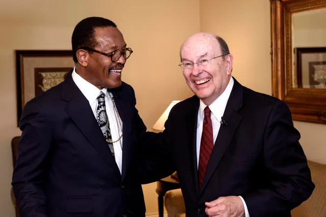 Elder Quentin L. Cook speaking at Princeton University. In these images he is talking to various members of the conference. They are all ethnic. Many people are milling around the room that the presentation was given in. 

Location: Princeton University in New Jersey. Elder Cook is speaking at a religious freedom conference at Princeton University in New Jersey July 26-27, 2017.