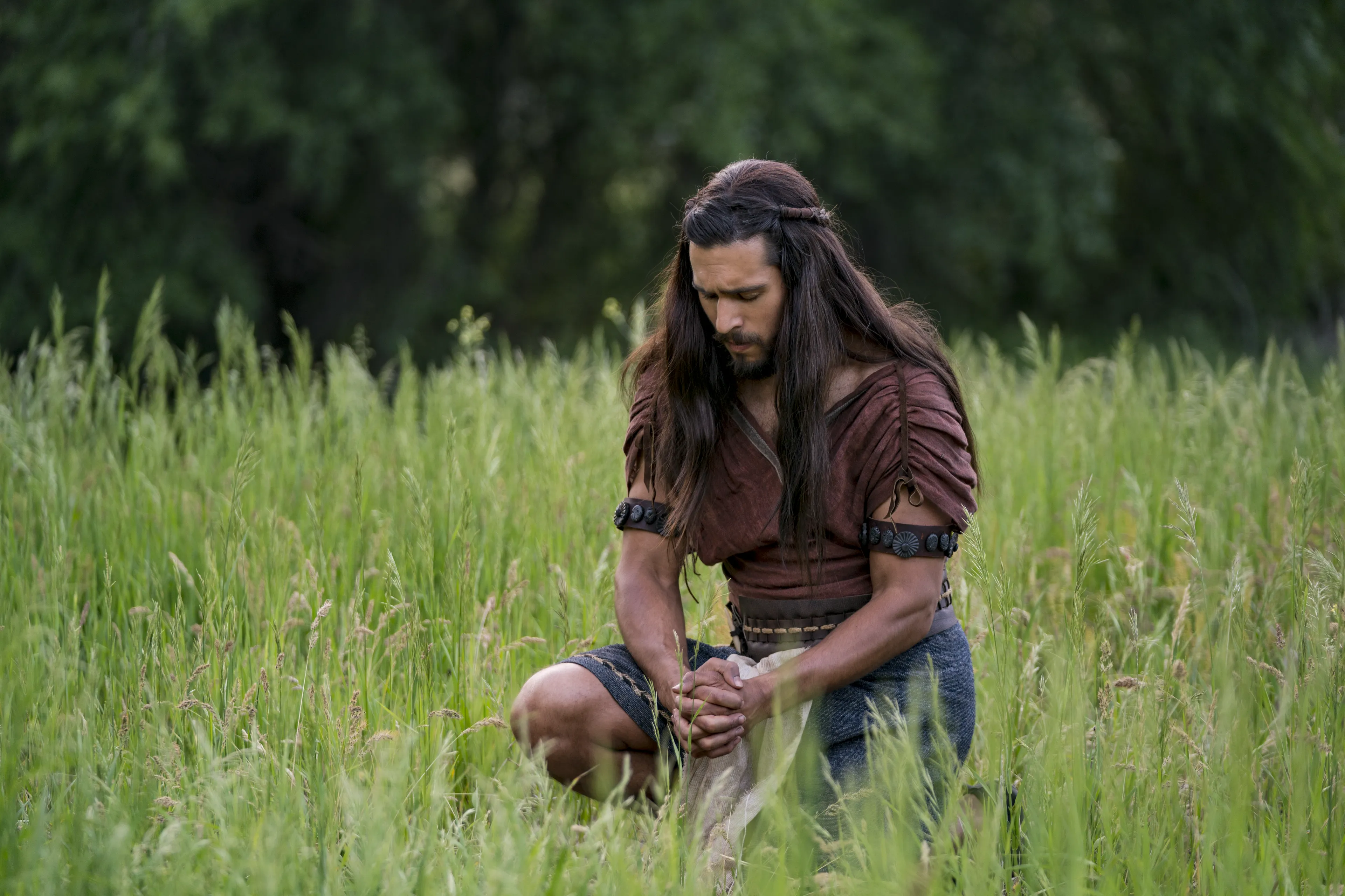Enos praying in a field.