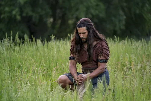 Enos praying in a field.