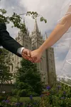 linked hands with Salt Lake Temple in background