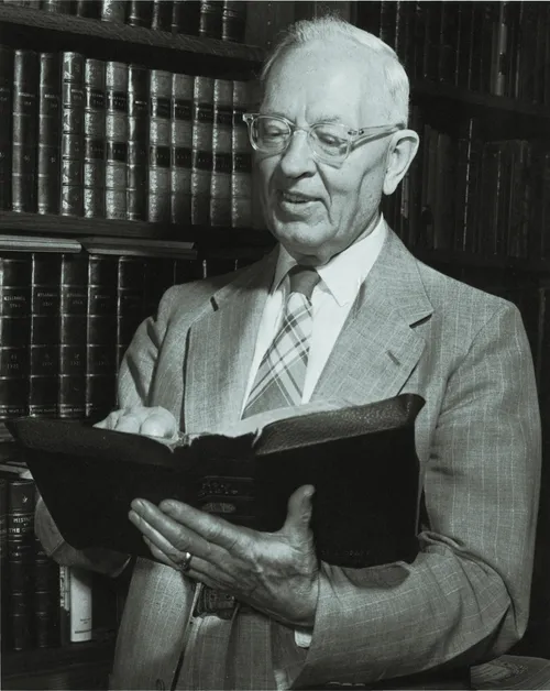 Joseph Fielding Smith holding open scriptures.