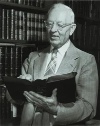 Joseph Fielding Smith holding open scriptures.