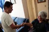 A man shakes the hand of an elderly woman after a ministering visit