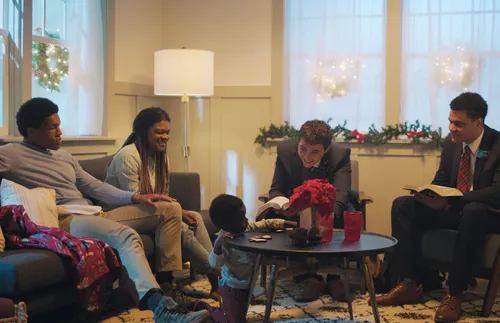 missionaries gathered with a family