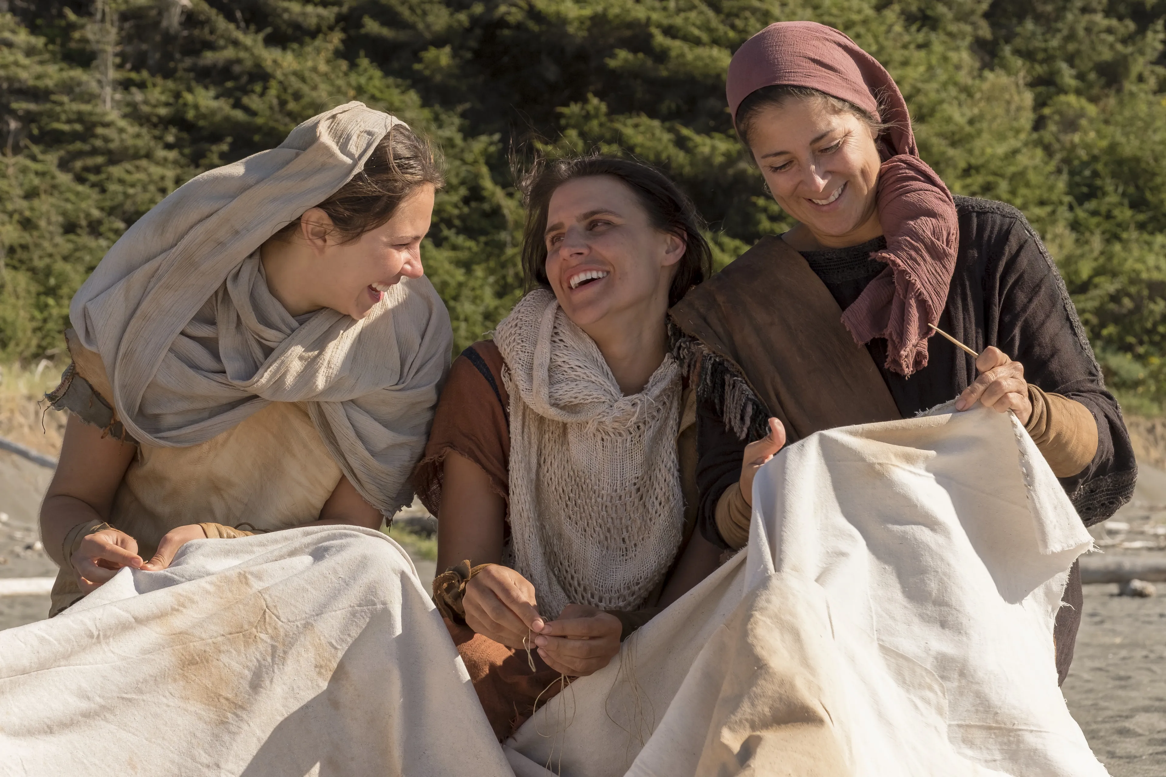 Ishmael's wife and daughters sew a sail.