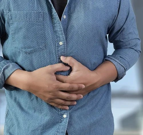 person holding injured stomach