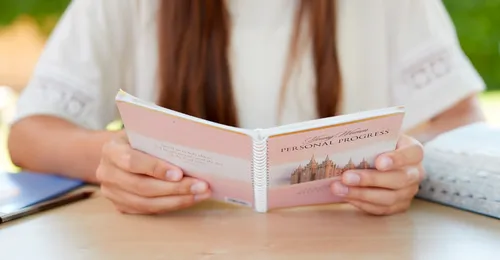 young woman reading Personal Progress