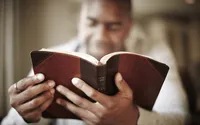 A man studies the Bible in his home learning how Jesus understands us