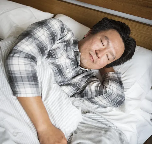 man sleeping in bed