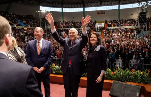 President Nelson standing next to others and waving at gathered Church members