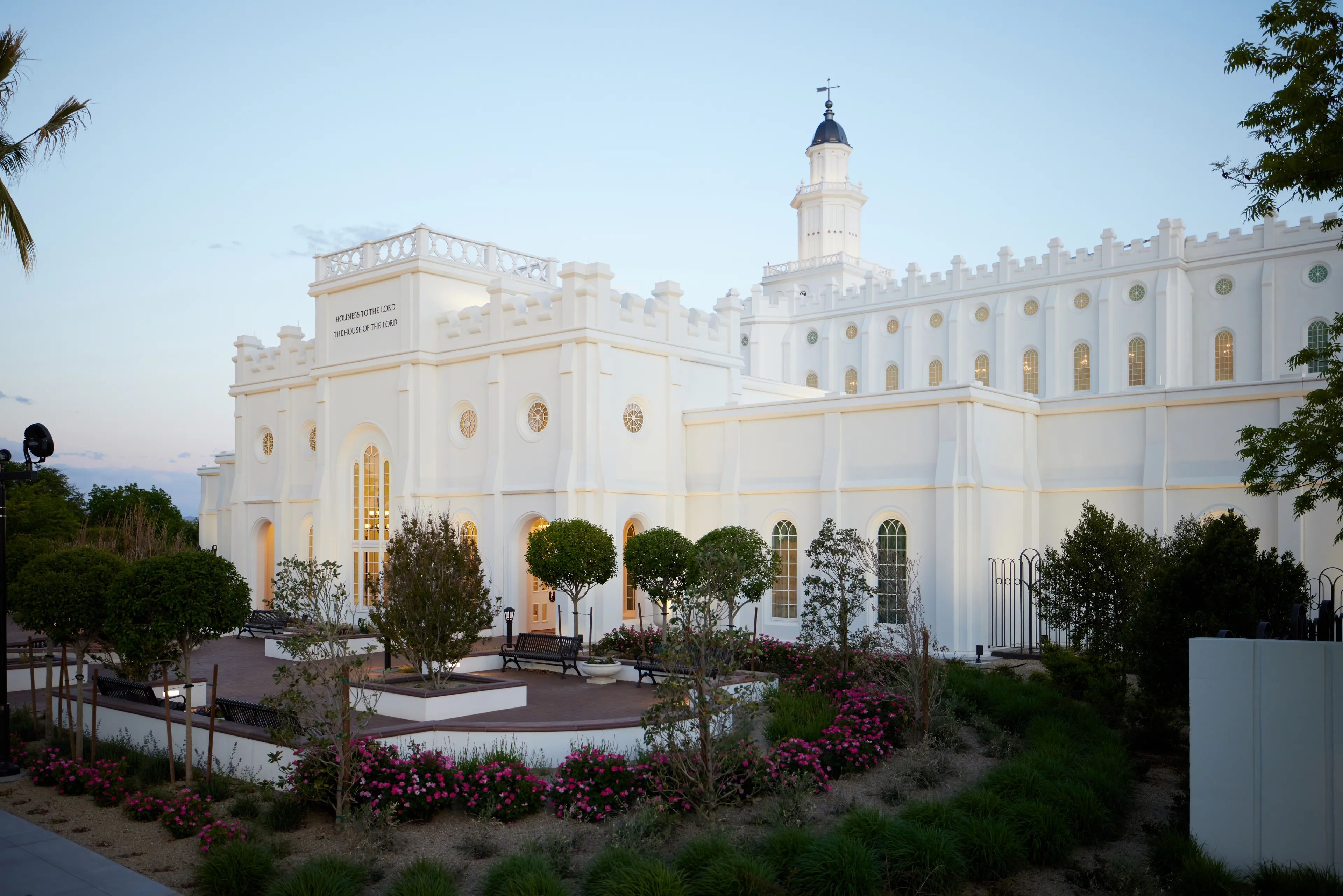 Exterior image of the St. George Utah Temple. The image features the temple set around trees surrounding the temple grounds. 