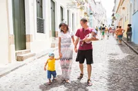 A family walk down a street enjoying each others company