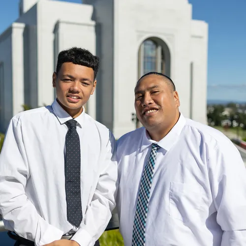 Cassidy and his son standing in front of the temple