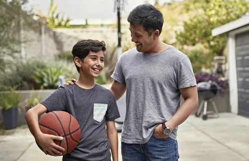 father and son with basketball