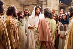 Jesus Christ raises a man from off the ground whom he healed by faith