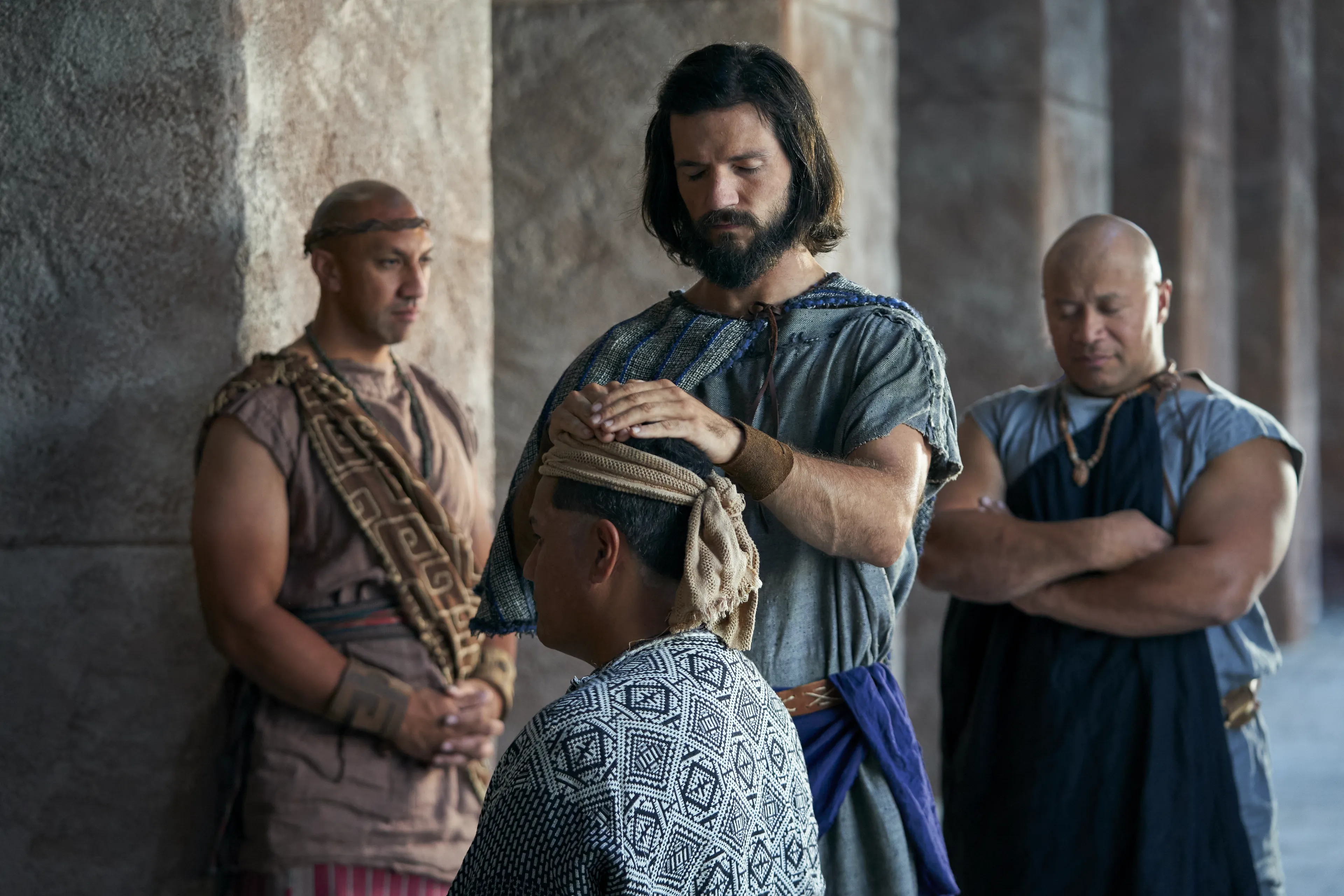 Alma the Younger blesses a man with the laying on of hands in the city of Zarahemla.