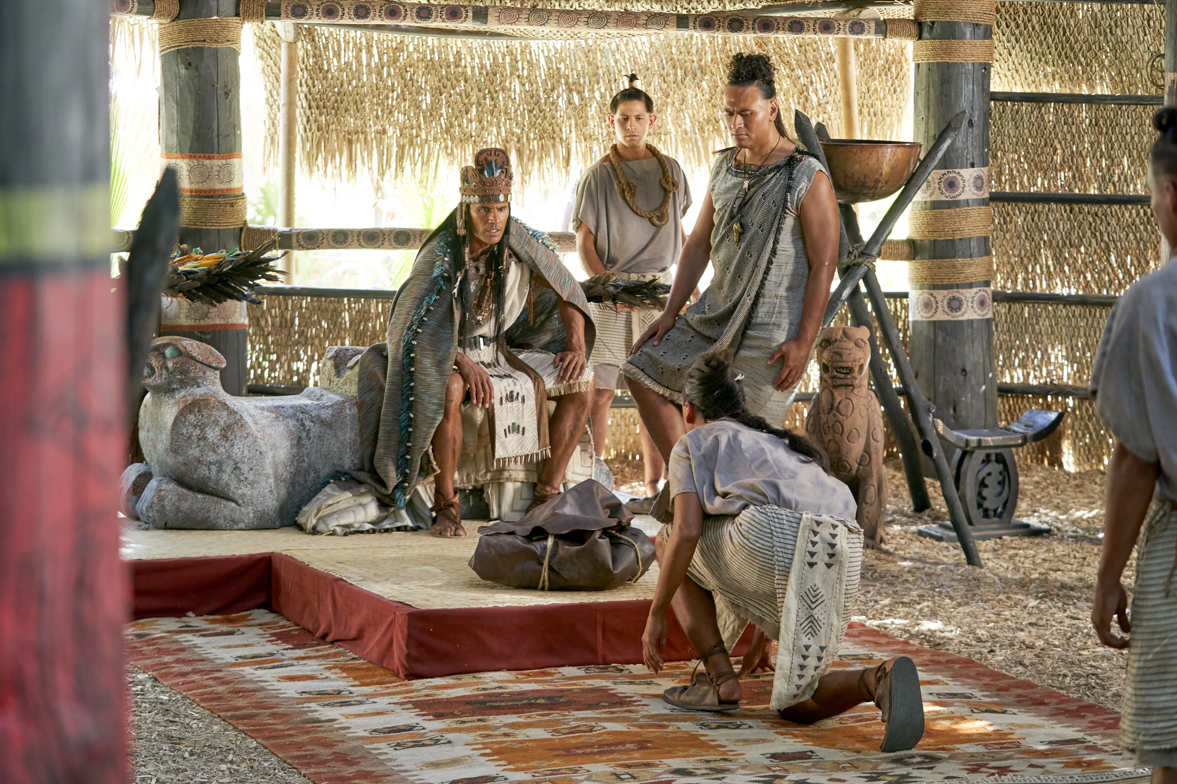 A closed bag, containing the arms of the Lamanites, is presented to King Lamoni by his servants in the land of Ishmael.