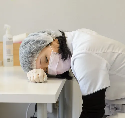 woman resting on desk