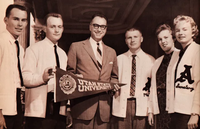 Quentin L. Cook (far left) and Utah State student body officers present Aggie pennant to Governor William Francis Quinn, Hawaii’s first governor, circa 1959.