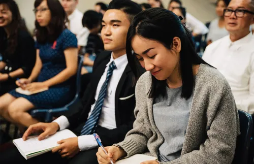 woman smiling and writing in a notebook
