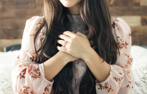 woman with her hands over her heart