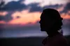woman looking at sunset