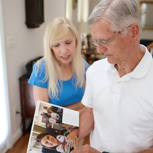 man and woman looking at photos