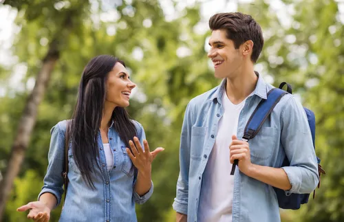 woman and man talking with each other outside
