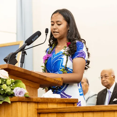 young woman speaking at pulpit