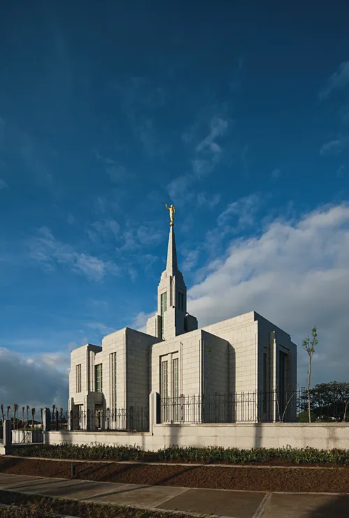 The Cebu City Philippines Temple on a sunny day, with a few clouds behind the spire.