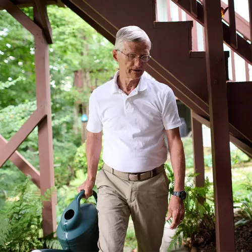 man walking with watering can
