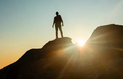 man standing on top of a hill