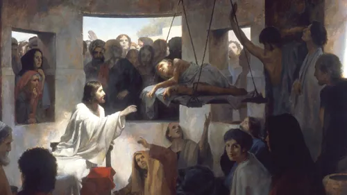 Jesus reaching toward a man being lowered through the roof