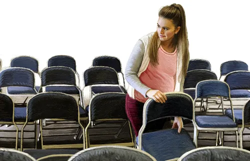 woman setting up chairs