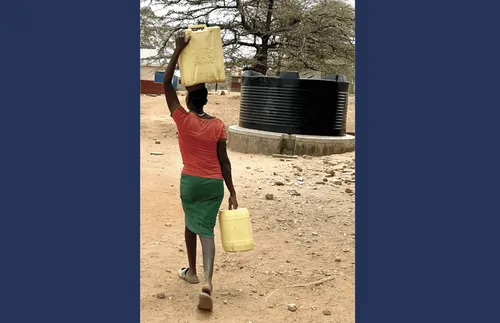 African woman carrying water.