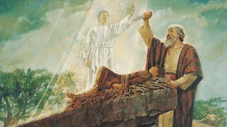 The Old Testament prophet standing beside an altar.  Abraham's son Isaac is strapped to the altar.  Abraham is holding a dagger in the air as he prepares to sacrifice Isaac. An angel is appearing before Abraham and commanding him to not sacrifice his son.