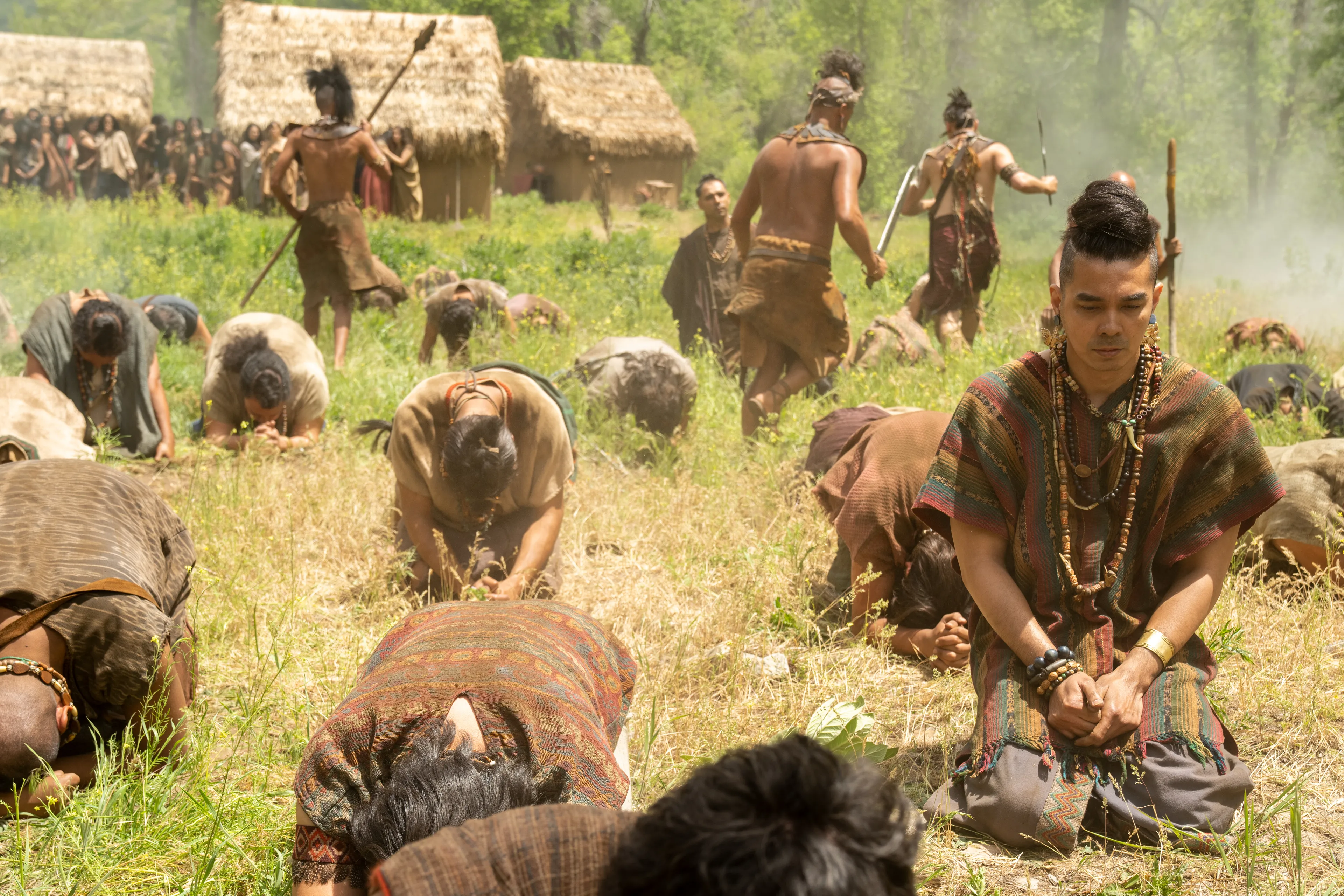 The men of Anti-Nephi-Lehi kneel and pray as the Lamanites attack them.