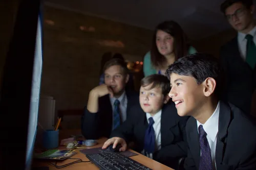 young men looking at computer screen