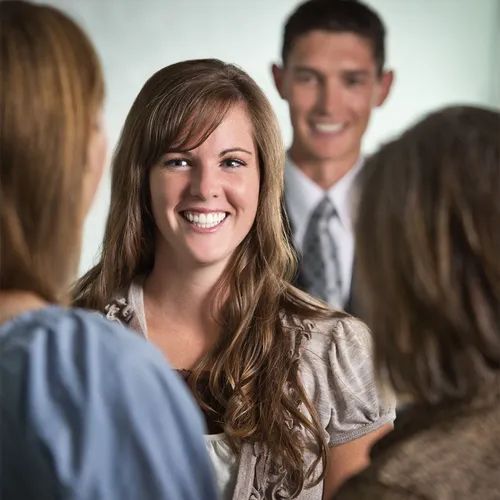 young woman smiling at friends