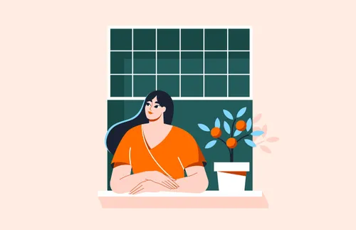 a woman standing and looking out her window