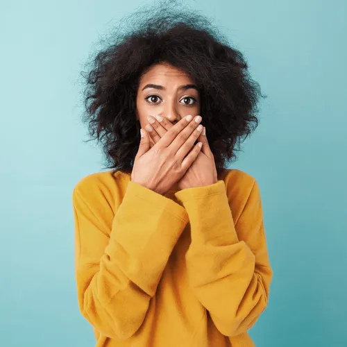young woman covering her mouth